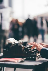 Person typing on a typewriter